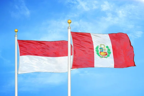 Indonesia Peru Two Flags Flagpoles Blue Cloudy Sky Background — Stock Photo, Image