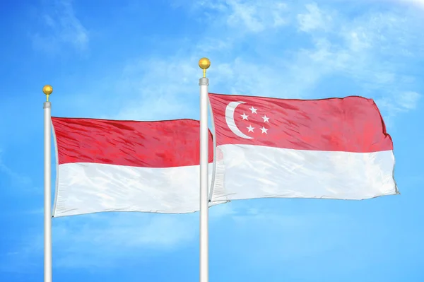 Indonesia Singapore Two Flags Flagpoles Blue Cloudy Sky Background — Stock Photo, Image