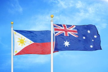 Filipinler ve Avustralya bayrak direkleri ve mavi bulutlu arka planda iki bayrak