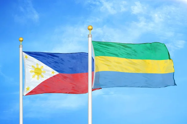 Philippines Gabon Two Flags Flagpoles Blue Cloudy Sky Background — Stock Photo, Image