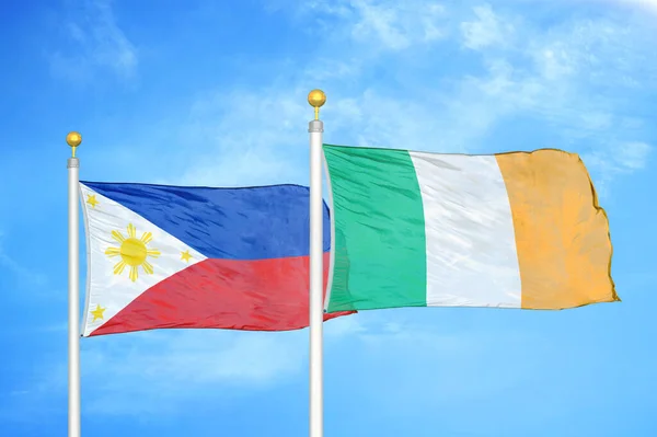 Philippines Ireland Two Flags Flagpoles Blue Cloudy Sky Background — Stock Photo, Image