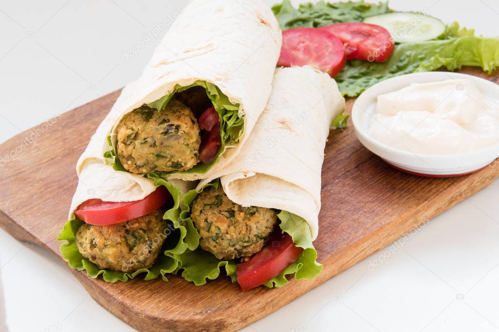 Falafel and fresh vegetables rolled in pita bread