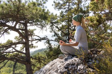Lotus poz dağın tepesinde oturan yoga kadın. Yoga kavramı.