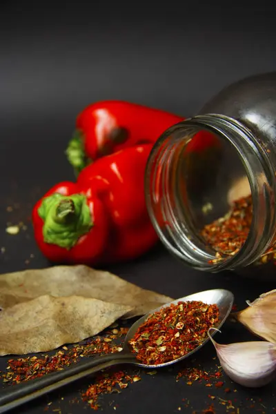 Bir cam kavanoz ve kaşık arka plan kırmızı tatlı biber ve sarımsak baharat 