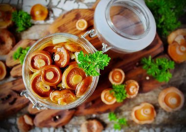 marinated mushrooms Lactarius in a glass jar clipart