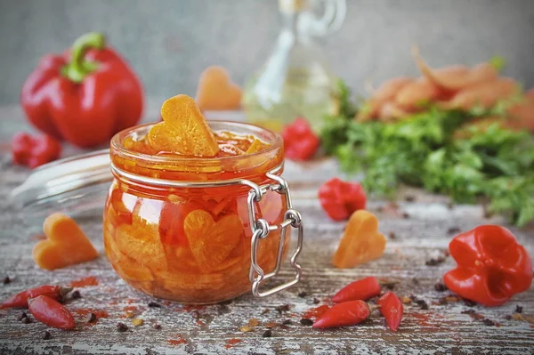 homemade pickled carrots with garlic and chili in glass jars