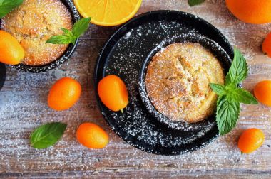 Turuncu kek, kek eski tezgah ve taze portakal, kumquats ve nane Üstten Görünüm
