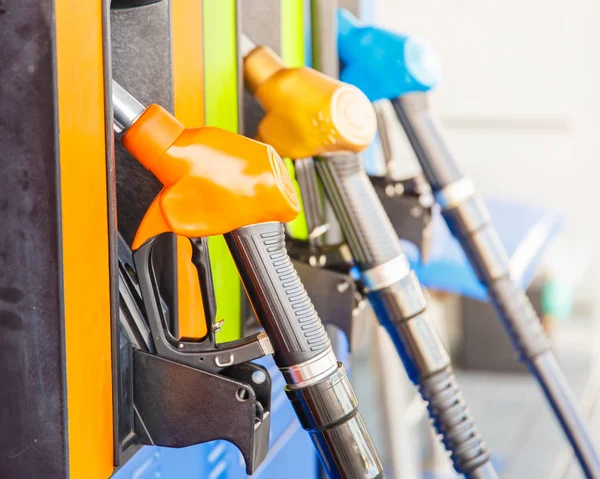 Gas pump nozzles in a service station — Stock Photo, Image