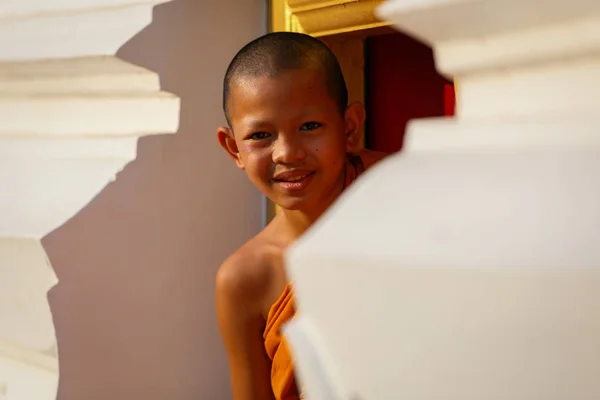 Young Novice monk smile in monastery the big window temple at Ayutthaya historical park in Thailand