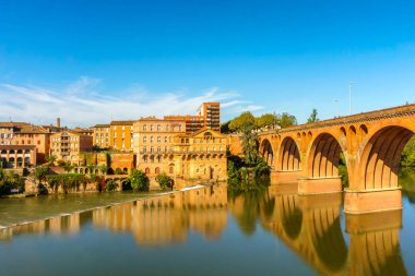 Albi in Southwestern France. Albi is a world heritage UNESCO site. Albi is famous for Toulouse-Lautrec and the Cathedral Saint Cecile. View of the Tarn River and the Cathedral Saint Cecile. clipart