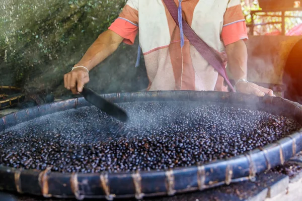 Close-up view of roasted coffee beans in man's hand — Stock Photo, Image