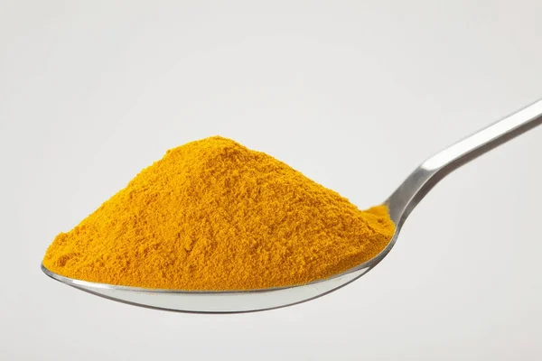 Spoon of ground, powder turmeric — Stock Photo, Image