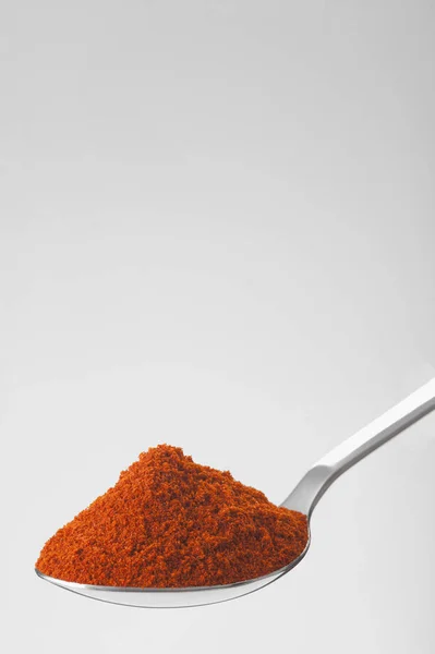 Spoon of powder red chili pepper — Stock Photo, Image