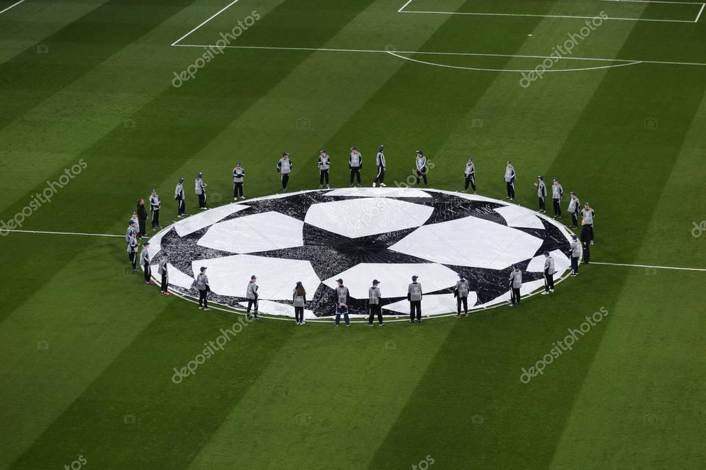 MADRID, SPAIN - FEBRUARY 17, 2017: top view of guys around Uefa Champions League logo on the grass of Santiago Bernabeu soccer stadium