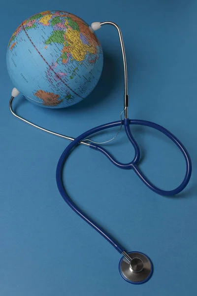 Vertical View Terrestrial Globe Stethoscope Blue Background — Stock Photo, Image