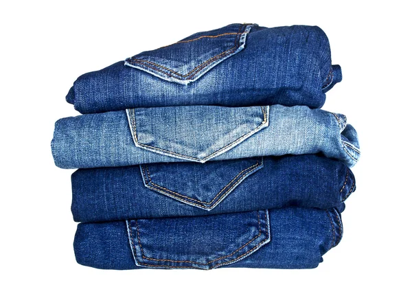 Lot of different blue jeans isolated on white background — Stock Photo, Image