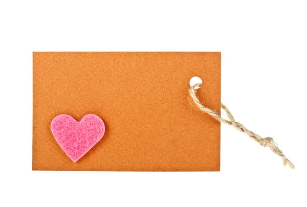 Brown paper label witn pink heart on white background — Stock Photo, Image