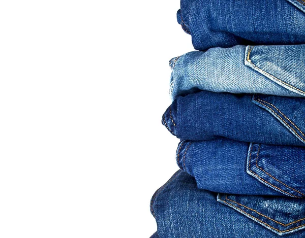 Sok különböző blue Jeans elszigetelt fehér background — Stock Fotó