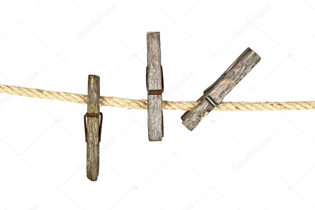 Old wooden clothespins on rope with copy space