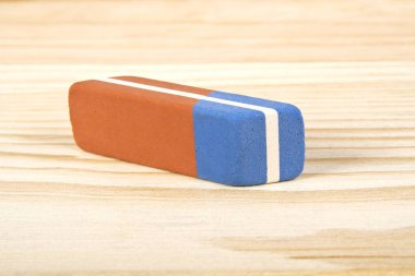 Eraser on wooden background clipart