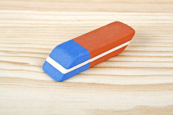 Eraser on wooden background