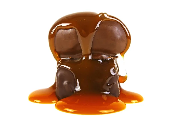 Two chocolate candies in caramel sauce on a white background — Stock Photo, Image