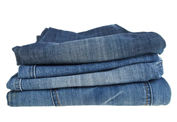 Lot of different blue jeans isolated on white background — Stock Photo, Image