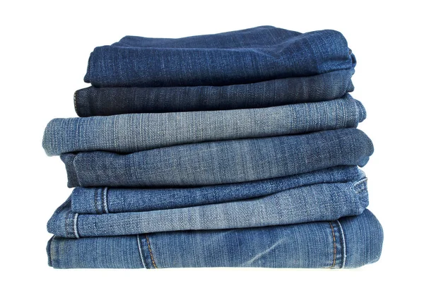 Lot of different blue jeans isolated on white background — Stock Photo, Image