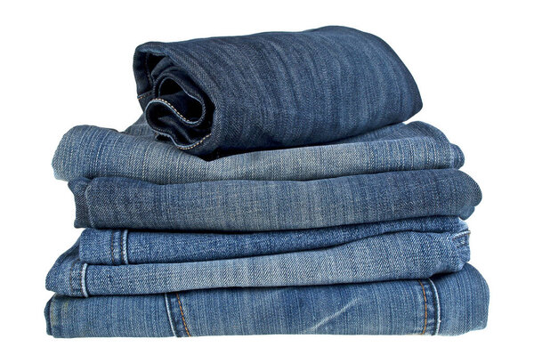 Lot of different blue jeans isolated on white background