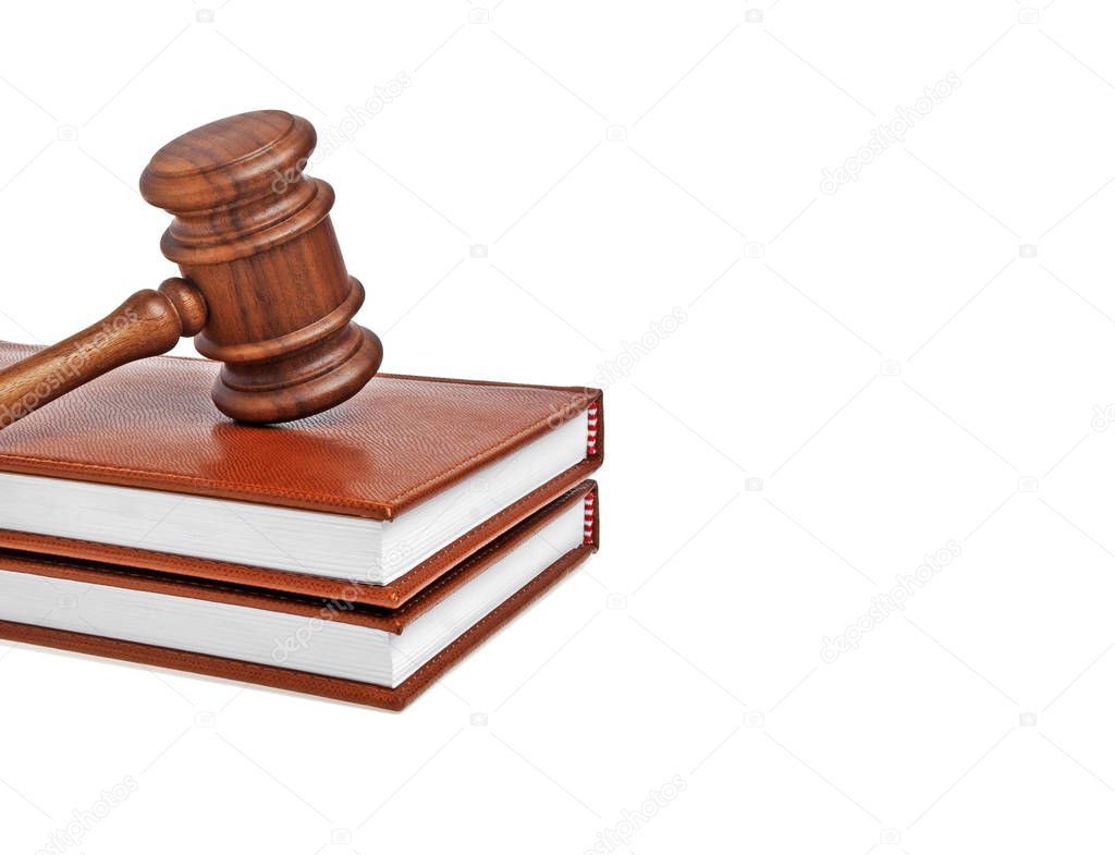 Wooden gavel and books on a white background