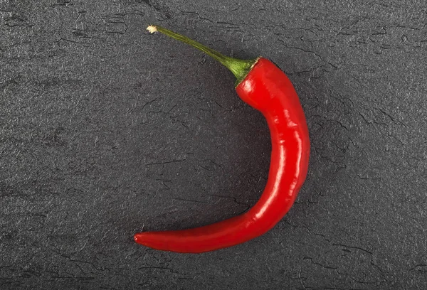Red chili pepper on black background, top view — Stock Photo, Image