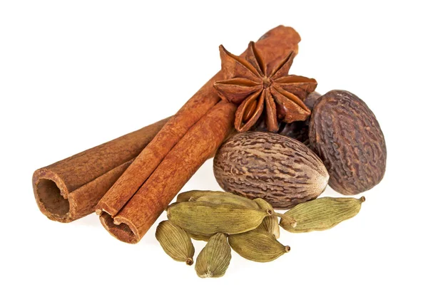 Spices - anise, cardamom, nutmeg and cinnamon sticks on a white — Stock Photo, Image