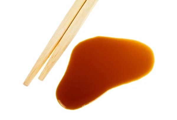 Splashes of soy sauce and chopsticks isolated on white backgroun — Stock Photo, Image