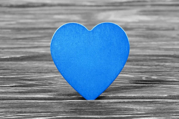Blue heart on wooden table
