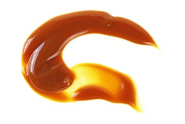 Beyaz arka plan üzerinde izole tatlı karamel sosu sıçrama