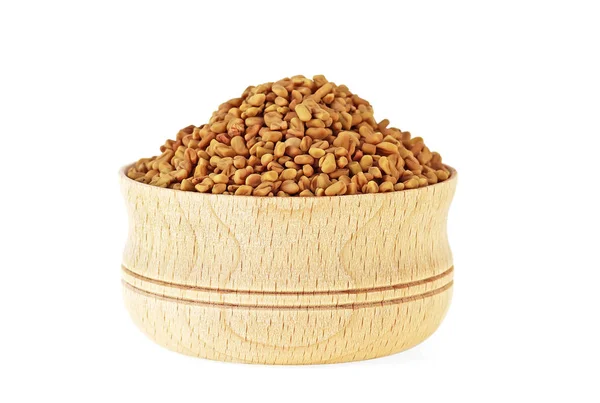 Fenugreek seeds in wooden bowl on white background — Stock Photo, Image