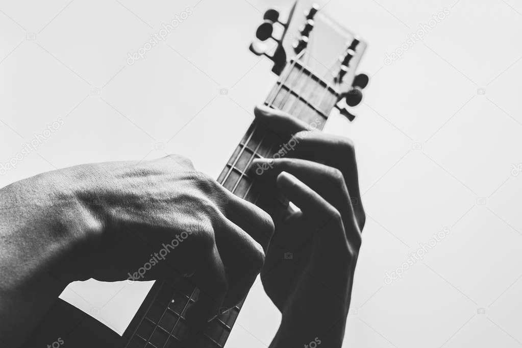 male musician hands playing guitar