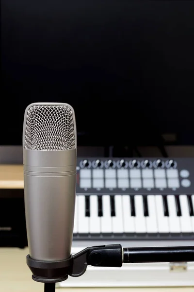 studio condenser microphone on midi synthesizer keyboard