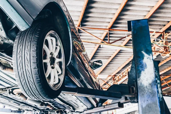 Car on lift in car repair station — Stock Photo, Image