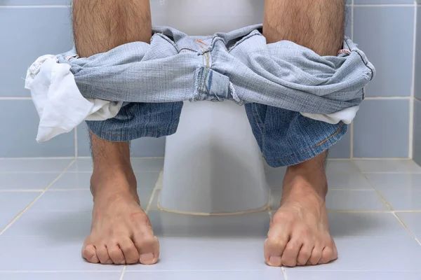 Man sitting on toilet, diarrhea Stock Picture
