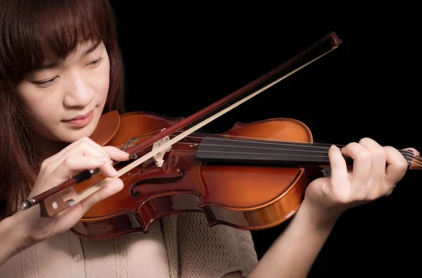 asian beautiful female musician playing violin