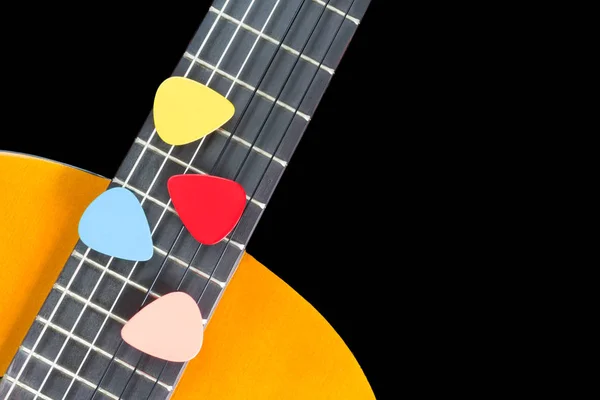 Colorful picks on guitar fingerboard — Stock Photo, Image