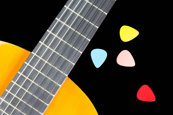 Colorful picks on guitar fingerboard — Stock Photo, Image