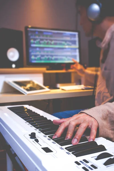Asian arranger hands working on keyboards in recording studio — Stock Photo, Image