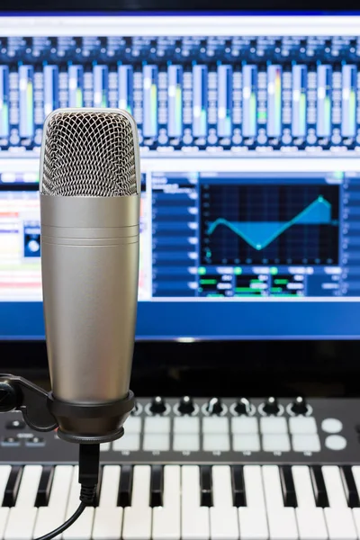 Studio condenser microphone, midi synthesizer knob & digital mixer on screen monitor for computer music or broadcasting concept background — Stock Photo, Image