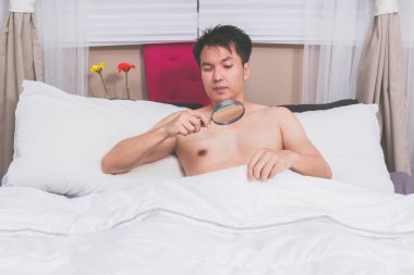 unhappy man with sex problem on bed. too small to see without magnifier clipart