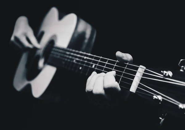 Manos de músico masculino tocando la guitarra acústica, blanco y negro — Foto de Stock