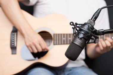 condenser microphone recording acoustic guitar sound in music studio clipart