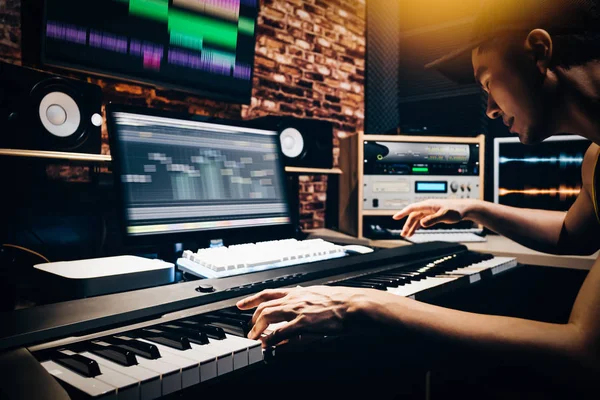 亚洲男性音乐编排手作曲在 Midi 钢琴和专业音响设备在数字录音工作室 — 图库照片
