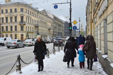St. Petersburg, Russia, February, 22, 2018. People in the snow walking along Nevsky prospect in winter in St. Petersburg clipart